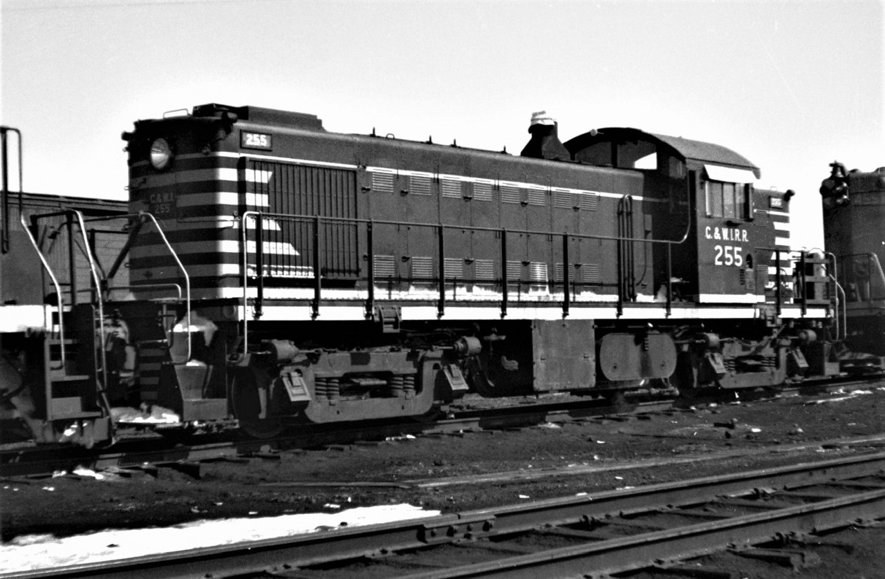Chicago and Western Indiana Railroad Alco/GE RS-1 #255 is shown passing through Capreol, Ontario in April 1966.  The 255 was built by Alco/GE (both shown on the builder's plate), s/n 77173, October 1949.  I have no idea where the unit was headed.