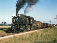 CPR D10f 836 cruises through the countryside at Ostrander with their Woodstock-bound train, predominantly made up of coal loads from Port Burwell <a href=http://www.trainweb.org/oldtimetrains/CPR_London/888a.jpg>off the car ferry “Ashtabula”.</a><br><br><i>Original Photographer Unknown, Al Chione Duplicate, Jacob Patterson Collection Slide.</i>