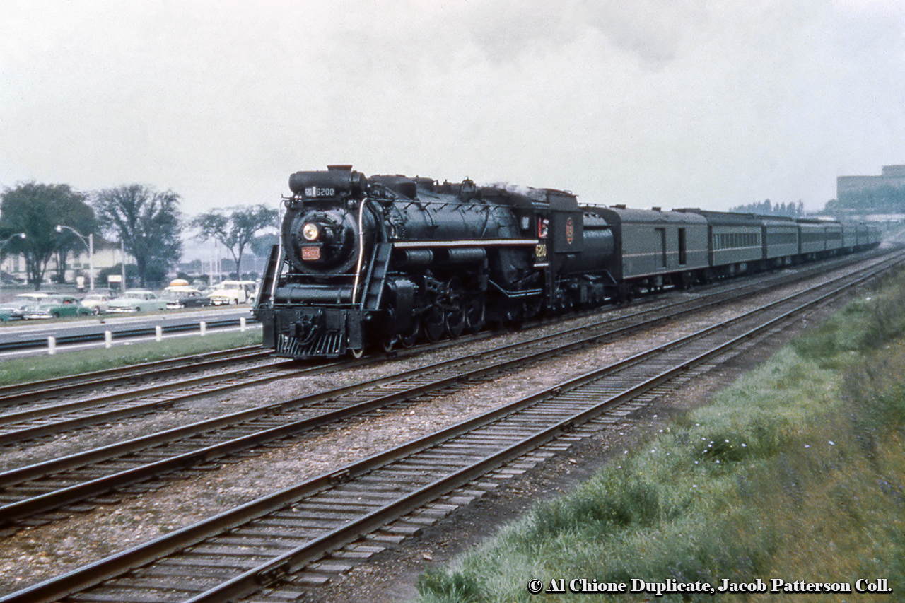 CNR U-2-g 6200 brings a morning commuter train through Sunnyside while motorists idle on the new Gardiner Expressway, this section opened in August 1958.  CNR 6200 is now on display at the National Museum of Science & Technology in Ottawa.Original Photographer Unknown, Al Chione Duplicate, Jacob Patterson Collection Slide.