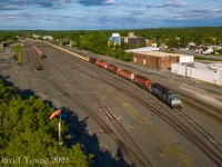 An overview of the west end of CP's North Yard at Kenora- once a fairly steady yard filtering cars for the local industries in town and along the line, now downgraded to storage only finds a work train tied down in track one with a loaded GREX "Slot Train" and an eclectic lash up of CMQ 9020-CP 5875- CP 6011- CP 6225- CP 6031 with CN ES44AC 3866 rounding out the consist. The crew will be called later in the evening in the failing light to double up track ten consisting of the GREX "Dump Train" plus a couple bulkhead flats before doubling onto the waiting empty IMS spine seen at the west end of track eleven, departing west for Winnipeg soon after. Over in track nine the tailend of a partially unloaded eastbound Herzog train bound for Dyment Pit (for reload) can be seen- it had the recently repainted/ re-stenciled CP 9022 with CP 6054....