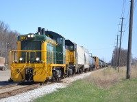 Freshly overhauled and dressed in its classy as-delivered paint scheme, Essex Terminal 105, an EMD SW1200 built in 1956, is stopped at the head end of the Weekend job while the crew grabs coffees from the Tim Hortons next to the yard. 105 was  overhauled by Lambton Diesel in Sarnia in late 2021, receiving a new 645 prime mover among various technical upgrades and a return to its original green and yellow livery, making it ETR's first heritage unit.