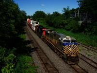 Ex-CREX CN 3919 (originally CREX 1343) and CN 3849 lead CN 120 round a curve. CN 3222 is mid-train as well.