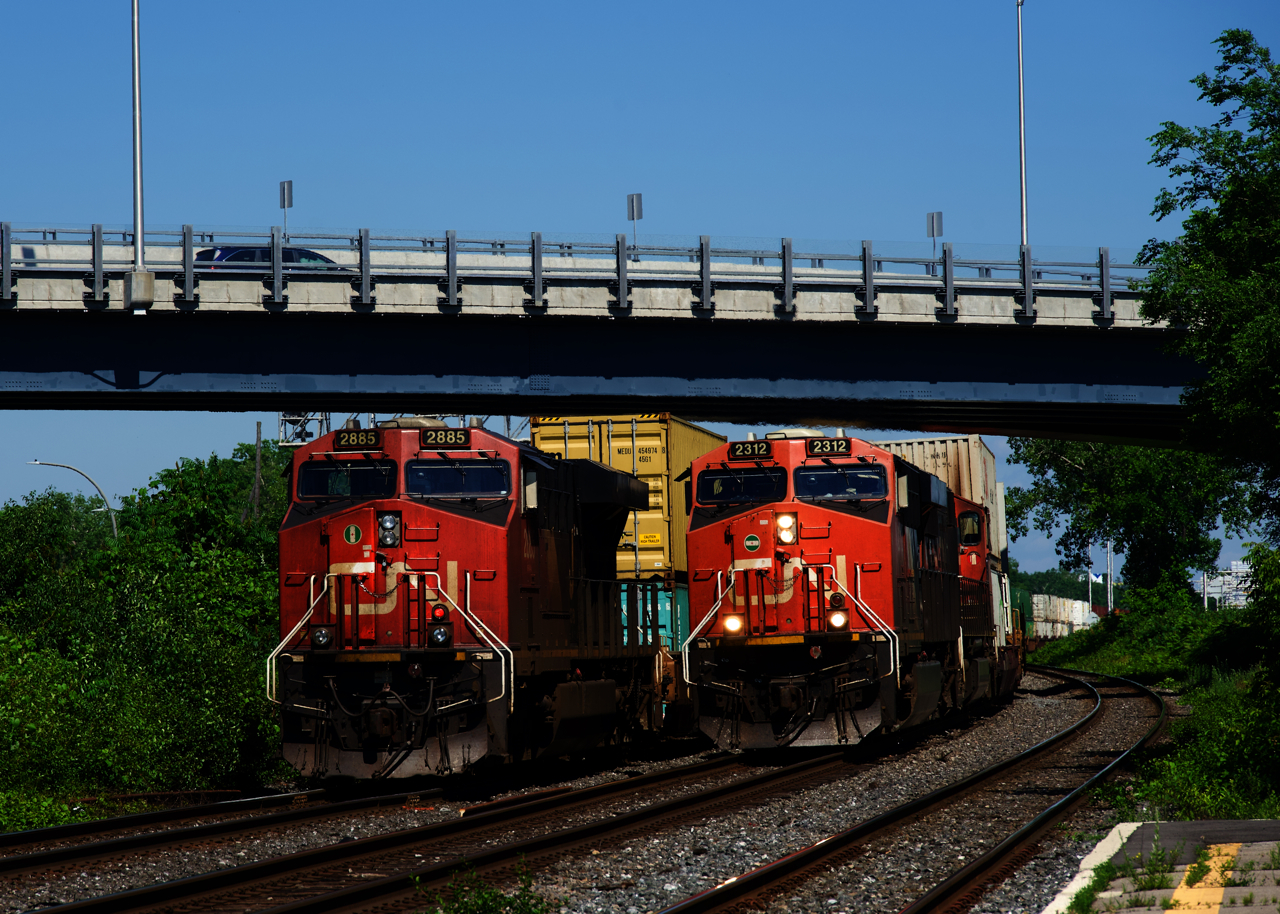 CN 123 (now a daily train from Halifax to Chicago) passes the tail end of CN 106 at Dorval after doing extensive work in Taschereau Yard.