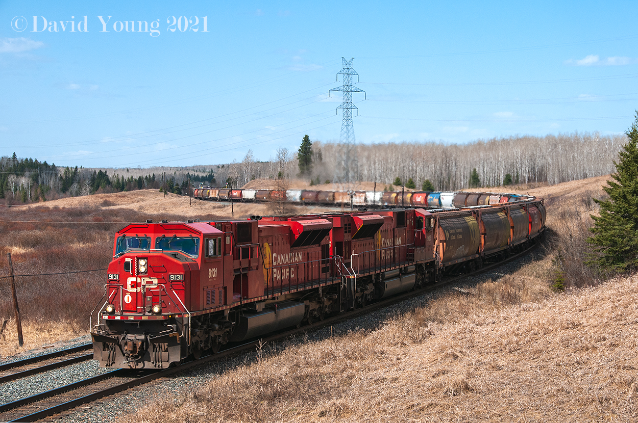 The return of the Mac's. Having being laid up the bulk of 2009, a number of SD90Mac's were reactivated throughout 2010 and were fairly common to see in the grain pool. Here we see CP 9131-9125 in full dynamics as the engineer completes navigating the heavy grade descent eastward out of Buda and into Finmark.