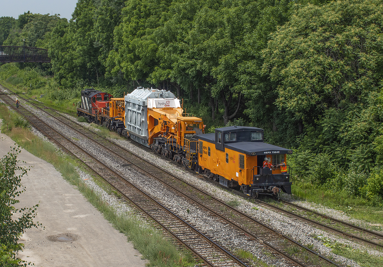 Crawling onto the N&NW spur at 1.5mph, 4130 gently shoves HEPX 200 and transformer down to the port at Federal Marine Terminal Ltd.  Returning from repair, the transformer will be loaded on the ship Blair McKeil for shipment to Sandusky, Ohio.