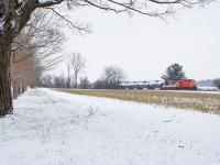A light dusting of snow is in the air as the St. Thomas job cuts across the open fields just east of Putnam with a pair of GP9s running long hood forward. Having a few hours of free time, I had been headed to St. Thomas after getting word LDSX 1597 had been dropped overnight for GIO Rail's new operation on the Cayuga Sub, and figured as long as I'm in the area, may as well take advantage of a short chase on the OSR. Shortly however, I would break off my chase near Mossley once I got word <a href=http://www.railpictures.ca/?attachment_id=47470>the Cayuga was alive</a> with the <a href=http://www.railpictures.ca/?attachment_id=47471>first train to Tilsonburg south</a> since April 2020.