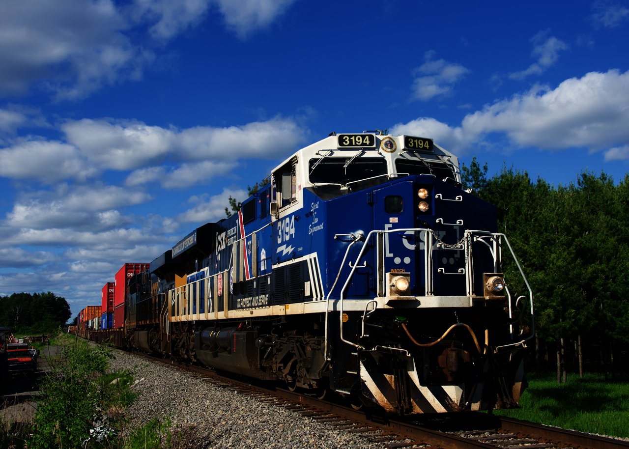 CN 327 with the Law Enforcement unit leading is about to pass a crossing at Mile 206.86 of the CSXT Montreal Sub.