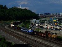 CN 321 is temporarily ahead of EXO 1211, but the latter will soon overtake the freight as both approach Turcot Ouest. 