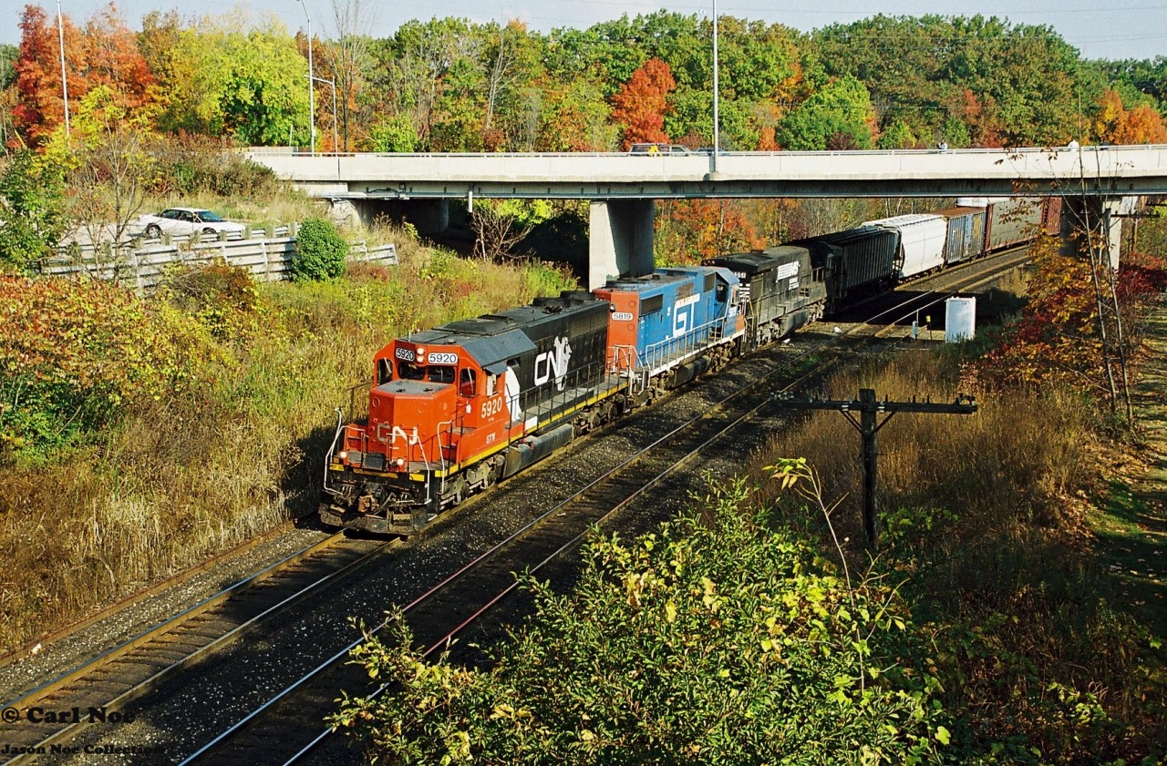 CN 387 with GTW 5920, GTW 5819 and NS 8051 is viewed heading westbound through Bayview Junction on the Oakville Subdivision during a sunny fall morning. The same power was photographed the previous day on CN 392 working Brantford yard on the Dundas Subdivision.