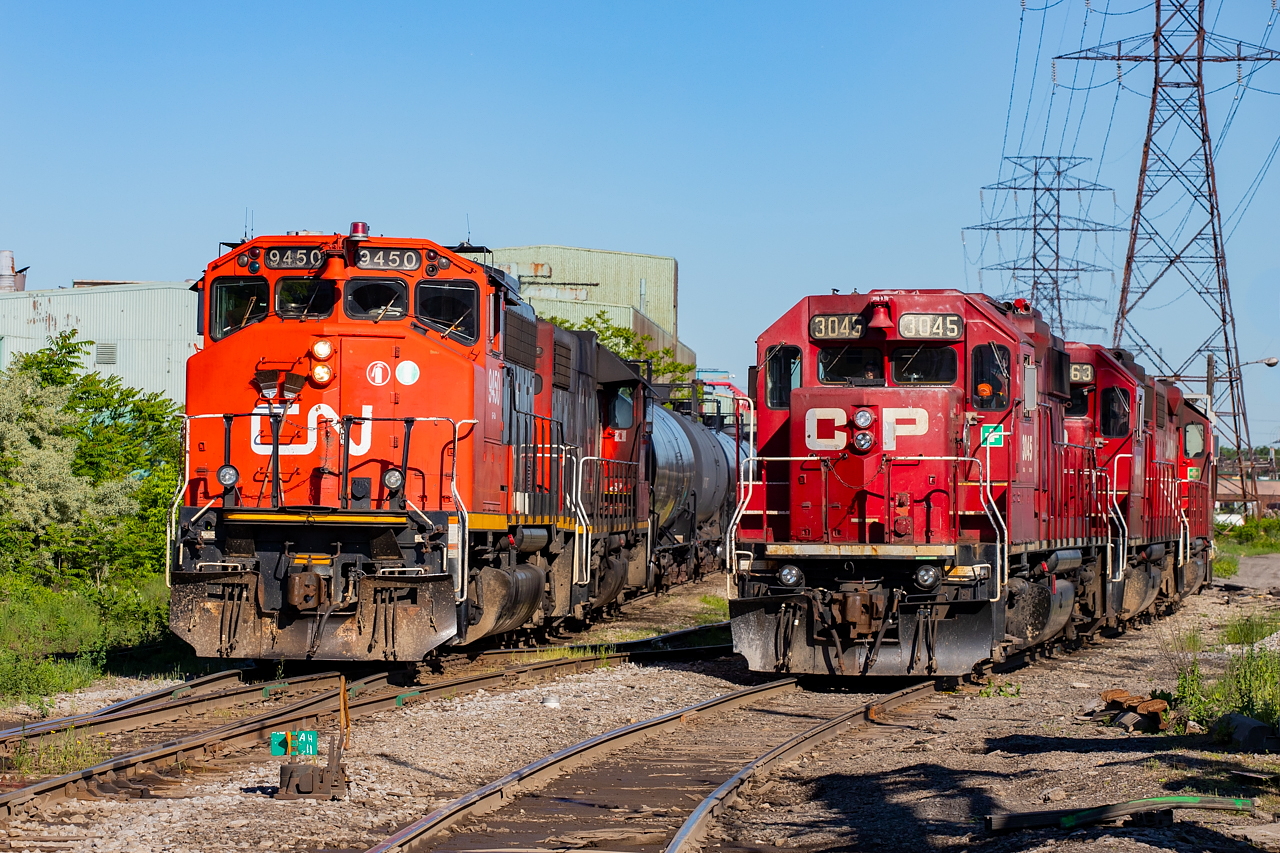 I was out shooting CP this morning on the Beach Branch when I saw CN coming behind in the distance. CP had one car for the interchange, and needing the Ottawa Street crossover to drop it, they held at Ottawa for CN to pass by. This allowed for this meet shot - one that I had been waiting for some time to do in proper light.