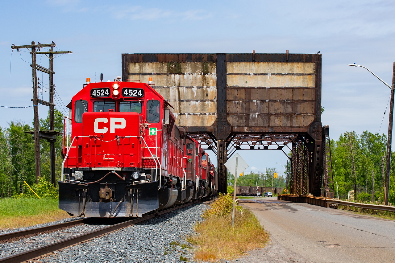 As mentioned here, the successor the CN U701, CP 822, arrived into Thunder Bay with 100 coke loads for TBTL on June 18. On the afternoon of June 19, the 0630 Yard Job went over light power McKellar Island to retrieve the train. If you look through the bridge to the right, you can see a view of the cars used for the operation - the same type used on the CN trains.  This had been a rather stormy day up until this photo, and a series of delays over at TBTL allowed enough time for some sun to come out for this shot.