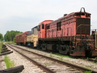 Ontario Southland Railway (OSRX) 506 and OSRX L3 along with a former CP Rail baggage car and some track equipment are viewed during a summer afternoon in the sleepy village of Mount Elgin on the former CP Port Burwell Subdivision.