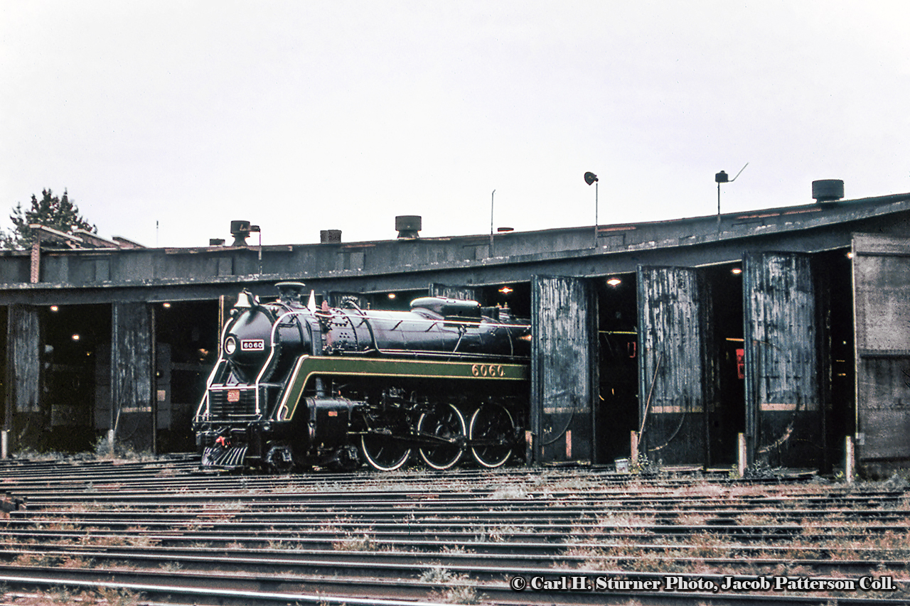 A desolate scene at Spadina finds 6060 poking out of the roundhouse prior to making a run to Niagara Falls.  Note the steam generator cars in the stalls at left.Carl H. Sturner Photo, Jacob Patterson Collection Slide.