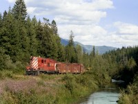 Tie gang camp cars lifted from the Slocan Lake barge head westward to Nakusp on the isolated Kaslo Sub. The train is following Bonanza Creek near the summit of Valhalla Range