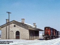 Via Rail train 663 zips past the shuttered St. Mary's Junction station with a pair of CN 3100 series RS18s on the point.  For a number of years, the building has sat boarded up surrounded by fencing, but has finally seen a new use in recent years.  <a href=https://brokenrailbrewing.ca/>Broken Rail Brewing,</a> a small brewpub, has spent the last few years restoring the station and <a href=http://www.railpictures.ca/?attachment_id=26906>the former GTW caboose</a> on the property with plans to use it as a lunch counter or food truck style setup in the future.  For now, the station is once again in use by the community and has bee fairly busy the last few times I've been past.<br><br><i>Original Photographer Unknown, Jacob Patterson Collection Slide.</i>