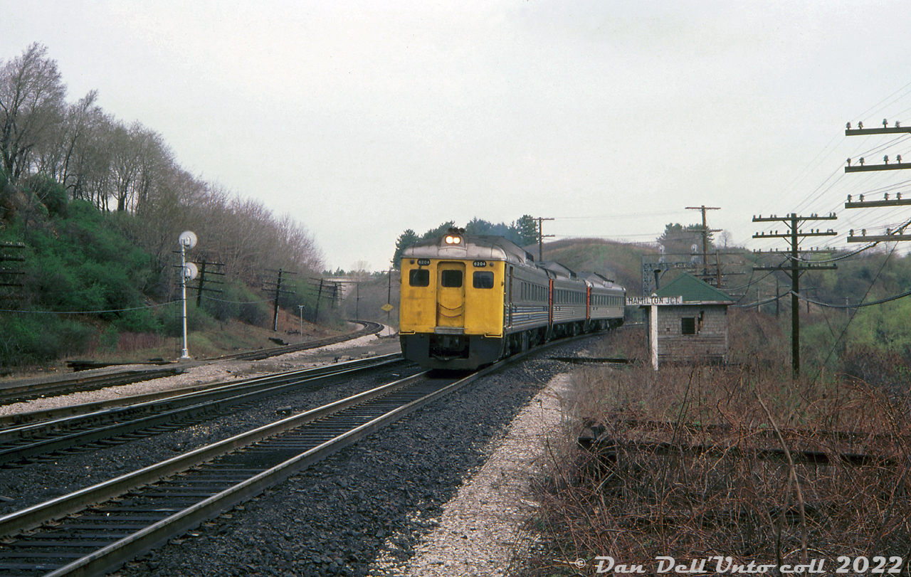 Three VIA Budd cars lead by RDC-2 6204 (the only one repainted, the other two still in CN paint) head westbound through Hamilton Junction past the namesake sign and an old sectionhouse trackside, nearing Hamilton Station on their trip from Toronto down to Niagara Falls. The track for CP's Goderich Sub is visible on the left (CN's "cowpath" is hidden by the lead RDC).

Writing on the slide mount by the unknown US photographer visiting quips "Just heading for Niagara Falls. Sure beats the traffic on the QEW".

Original photographer unknown, Dan Dell'Unto collection slide.