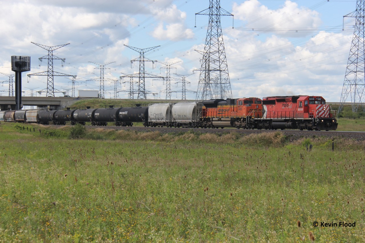 On August 19, 2020, CP 244 hustles towards Toronto with CP 6018 and BNSF 8465. This train was held up briefly at Guelph Jct. which allowed me to get ahead of it and shoot it just east of Highway 407.