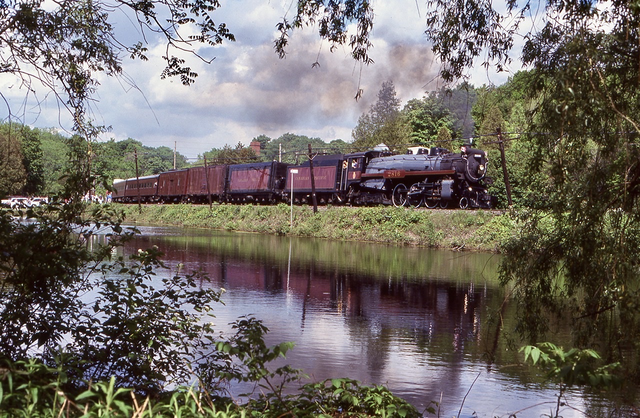 To this day this is still one of my favourite images. I made the most of 2816’s trips to Ontario back in the day. This day I was out with a good railfan friend and we chased the train westward from Streetsville. As the train was carrying a loaded GO train set on the tail end we were determined to get a shot or two with out the GO cars standing out. Knowing that the crossing in Campbellville would be loaded with railfans we decided to try the edge of the pond. Amazingly there were no railfans there to be found and the curve did a good job hiding most of the GO cars. It is unfortunate that the pond has grown in so much over the years. At Guelph junction the entire train used the wye before heading back to Toronto.