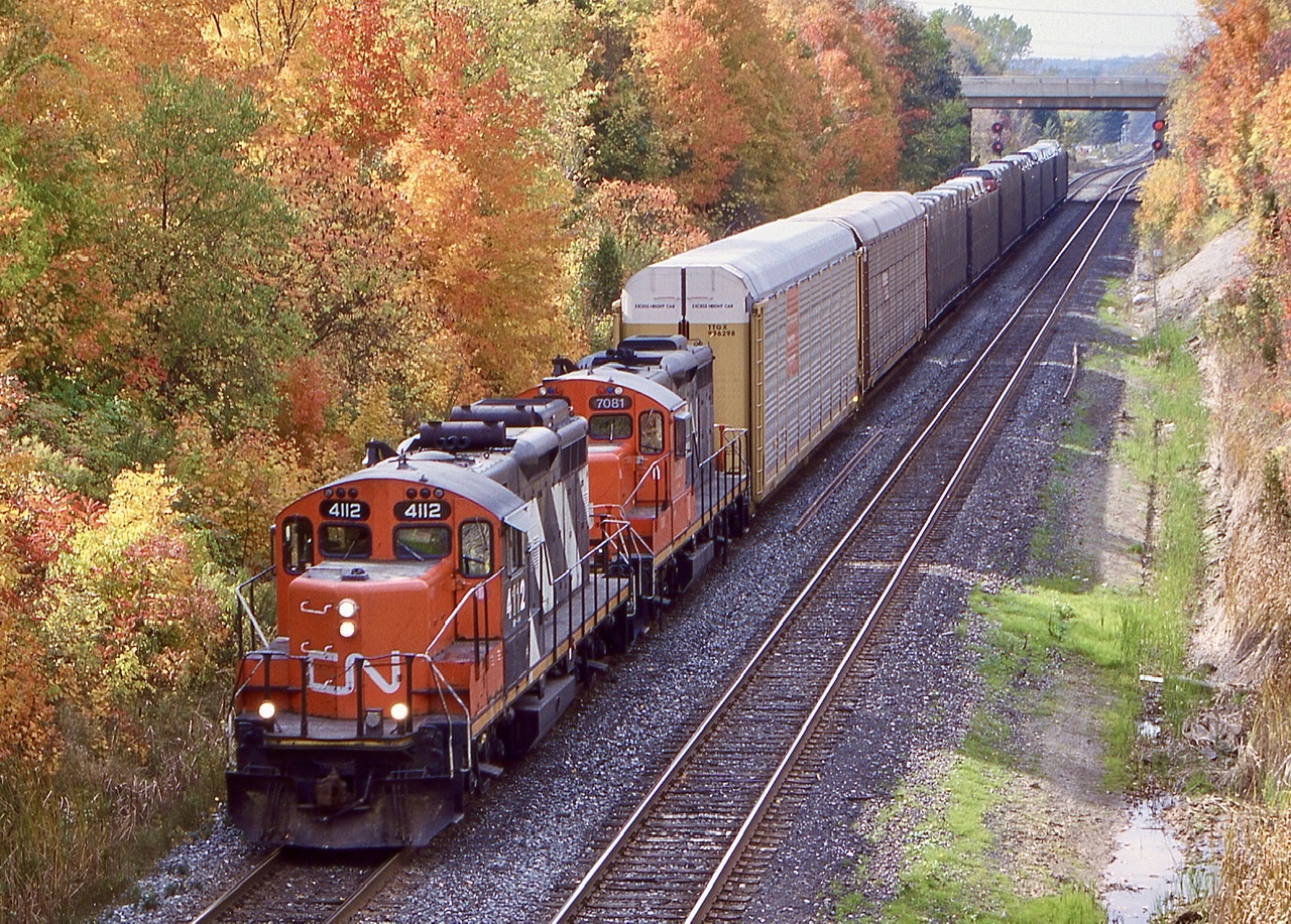 This was a bit of an oddball train that occasionally ran, often on the weekends, with solid GP9 consists. The main purpose was to exchange any loads/empties between Oakville and Toronto, typically all auto racks to/from the Ford plant. It was a treat catching the open auto racks too, so late in their lives.  While the wye was still intact at this time at Burlington West on the north side, I believe I only ever heard they used it once, otherwise a run around move was needed at Aldershot. The dramatic fall colours this day at Georgetown definitely made up for the sun being on the wrong side.