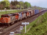 I always had a liking for CN’s wide cab GP40’s especially the ex GO Transit ones. Here one leads a westbound with a nice mix of power including a GTW GP38, another CN GP40 and CN/GTW GP40 6401 in “Operation Lifesaver” paint. I believe 6405 was the only other GP40 to wear this paint. There were other GTW painted units that also received “OL” paint. The train is just getting on the move again after stopping for about 45 minutes to fix a bad hose bag. I always loved this angle and hillside shots at Hardy and regret not taking them more often as this location today is very overgrown. The trailing cut off tank cars will be dropped at Paris for Railink to forward to Nanticoke.