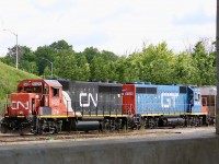 Picture window at Aldershot. CN’s last two former GTW GP40’s are framed by the underside of the Waterdown road bridge at Aldershot as they gather cars for their daily assignments. 