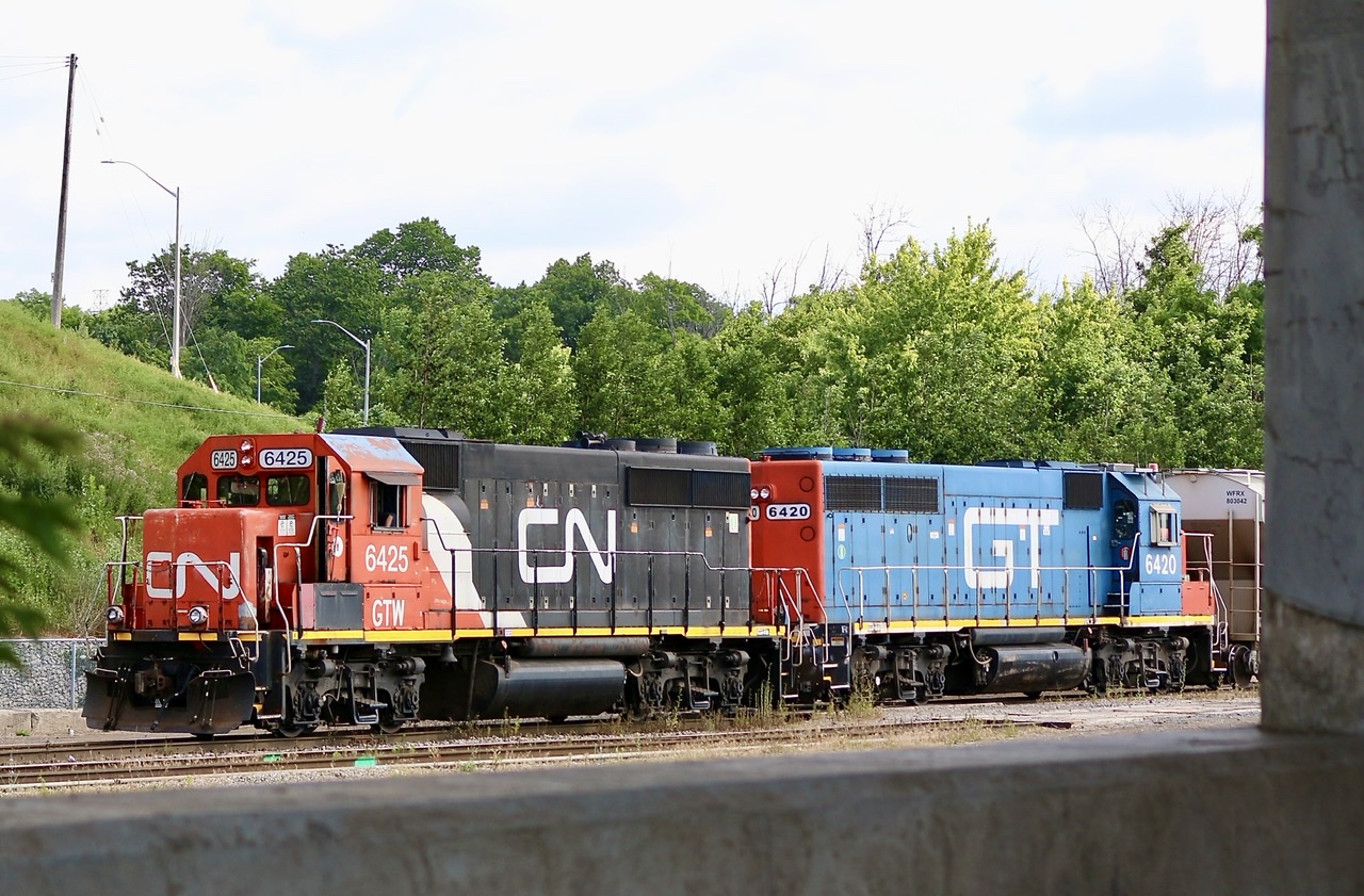 Picture window at Aldershot. CN’s last two former GTW GP40’s are framed by the underside of the Waterdown road bridge at Aldershot as they gather cars for their daily assignments.
