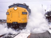 Steam spills into the cold air from beneath FP9A 6531 as it pauses at Burlington West with train 73.