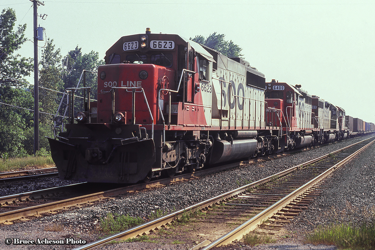 A westbound freight behind a quartet of SOO units heads west along the Galt Sub at the First Line crossing west of Guelph Junction.