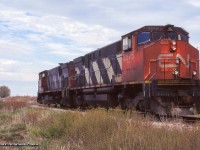 CN 3575, 3572 pause at Sandusk Road a few miles east of Jarvis on the Cayuga Sub after working the rail removal train all day.  When full, the train would head for Niagara Falls to unload, <a href=http://www.railpictures.ca/?attachment_id=40803>as captured by Arnold at Yager West.</a>