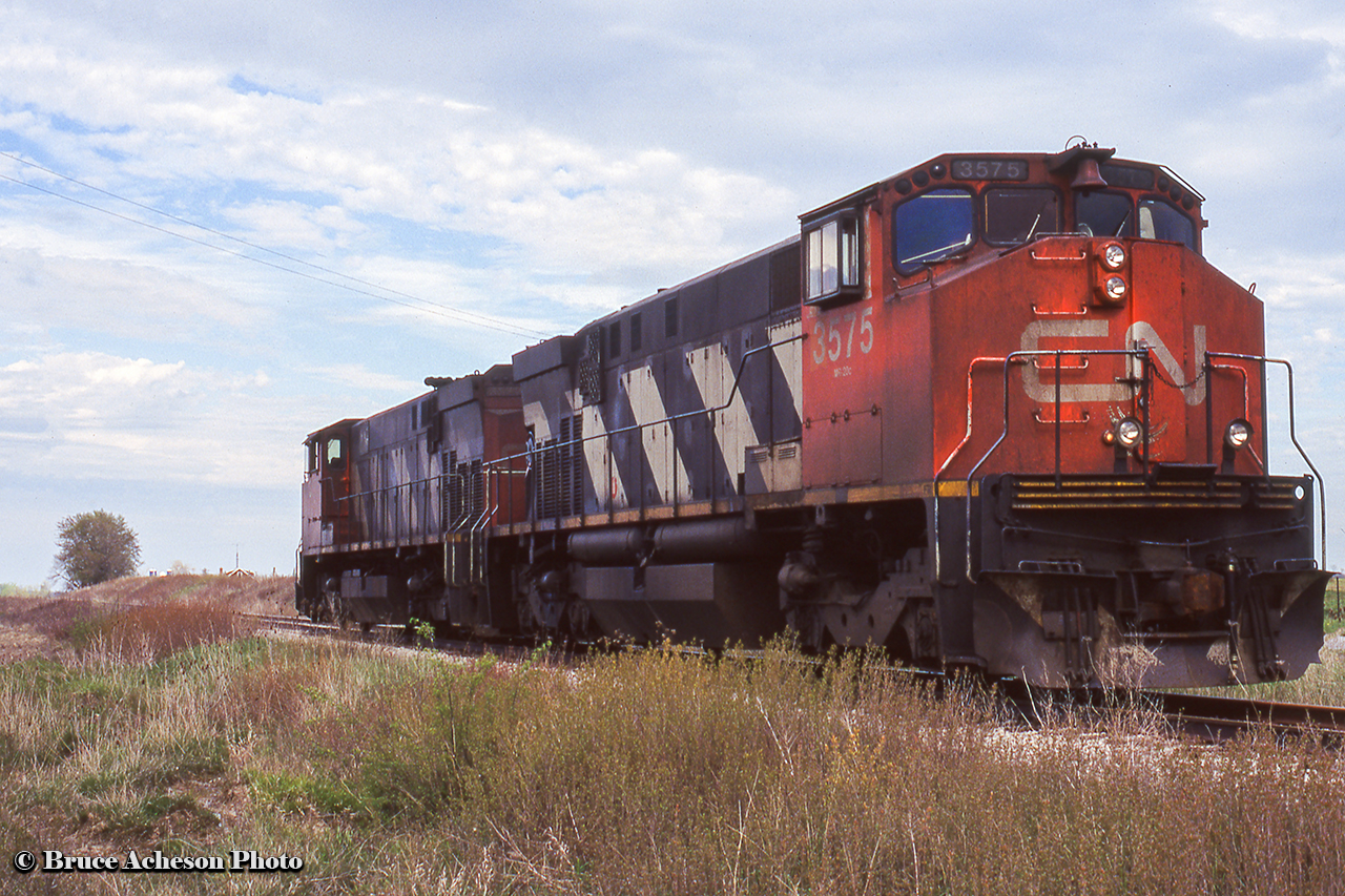 CN 3575, 3572 pause at Sandusk Road a few miles east of Jarvis on the Cayuga Sub after working the rail removal train all day.  When full, the train would head for Niagara Falls to unload, as captured by Arnold at Yager West.