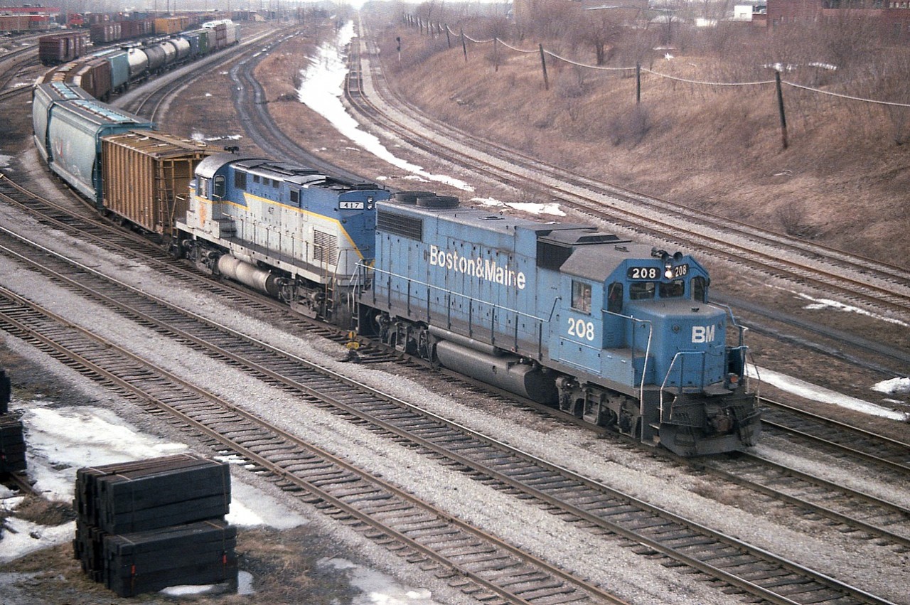 This is a classic example of my personal "good Old Days".  Hanging around Fort Erie on this day some years ago, for example; CR came over and departed, followed by D&H leading a B&M, and it went around the wye so I get now a B&M leading, and before it departed, C&O came over in the Chessie cat paint. Plus, at the shop were several CN A and B units and a few old Geeps.  These days were amazing.
This shot is of B&M 208 with D&H 417 (former 407) trailing, going back stateside after dropping off cars and now with traffic bound for the USA. Oddly enough, in this picture the yard tracks look very well used, whereas the mainline upper right, does not.