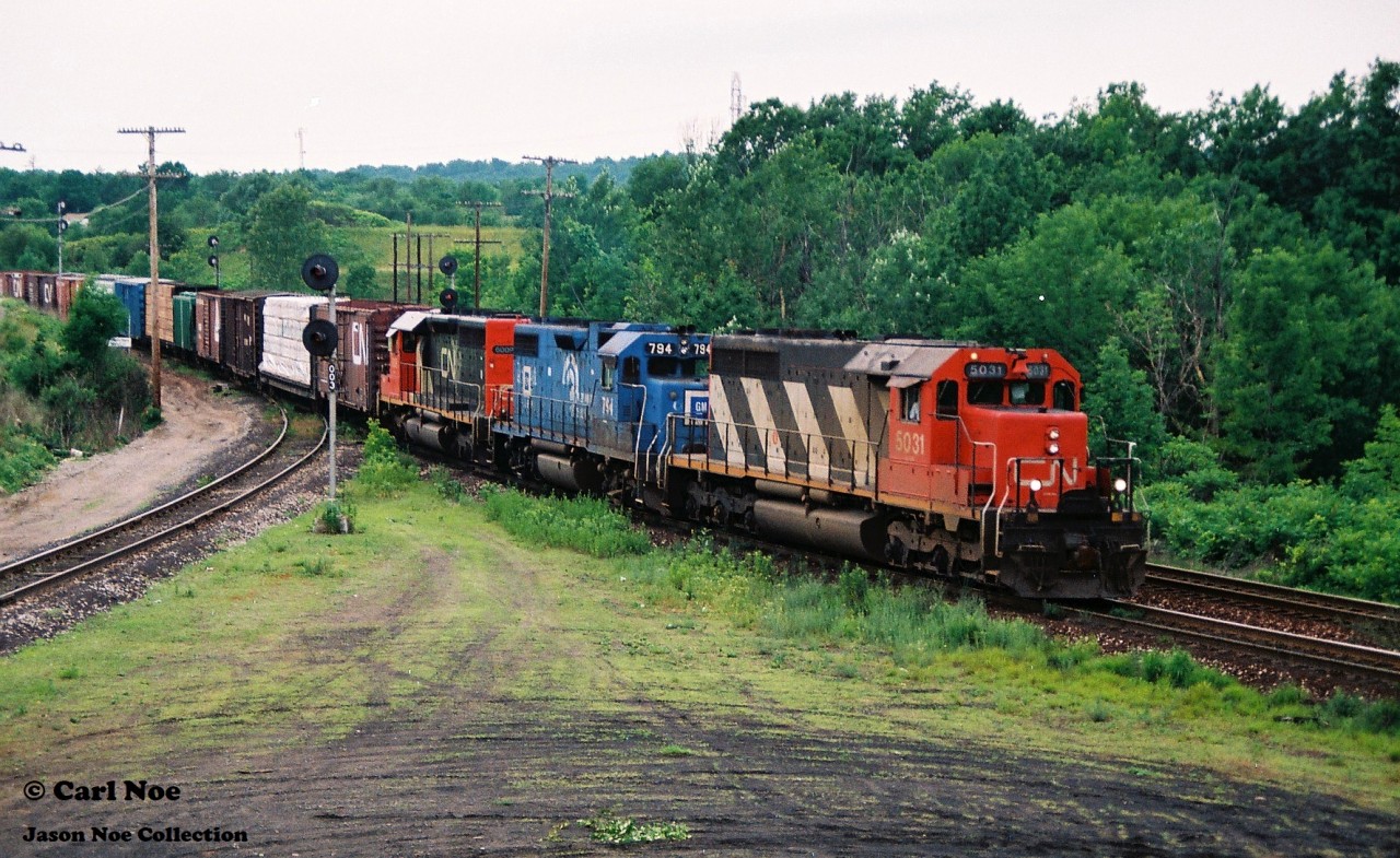 A CN eastbound is at Hamilton West on the Dundas Subdivision as it approaches Bayview Junction with 5031, EMD Leasing 794 and a recently rebuilt SD40u on June 26, 1994.