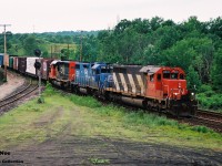 A CN eastbound is at Hamilton West on the Dundas Subdivision as it approaches Bayview Junction with 5031, EMD Leasing 794 and a recently rebuilt SD40u on June 26, 1994. 