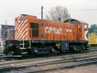 CP S10 6603, one of the local Toronto-area MLW switchers based out of John St. Roundhouse, sits near the yard office at CP's Lambton Yard in West Toronto, just above the Runnymede Road overpass. In the distance is CP caboose 436468, an old wooden "van" still with its tongue-and-groove siding and a rare paint variation (multimark painted on the cupola end, common practice on steel vans but very rare on wooden ones).<br><br>The MLW S10 was a "new" model introduced by MLW in 1958, but was basically identical to the later-carbody 660-horsepower S3 model that CP had been purchasing. CP opted for an order of 13 units, numbered 6601-6613. MLW later changed their 660hp switcher design to the S11 (which shared a common body style with the S13/RS23 units).<br><br>By the 1980's, the old steam-era Alco/MLW switchers were considered outdated and underpowered, and CP began to rebuilt GMD-built GP7/9 and SW units to replace most in yard and local service. 6603 was retired in early 1983, and scrapped at Angus Shops in Montreal.<br><br><i>Stan F. Styles photo, Dan Dell'Unto collection slide.</i>