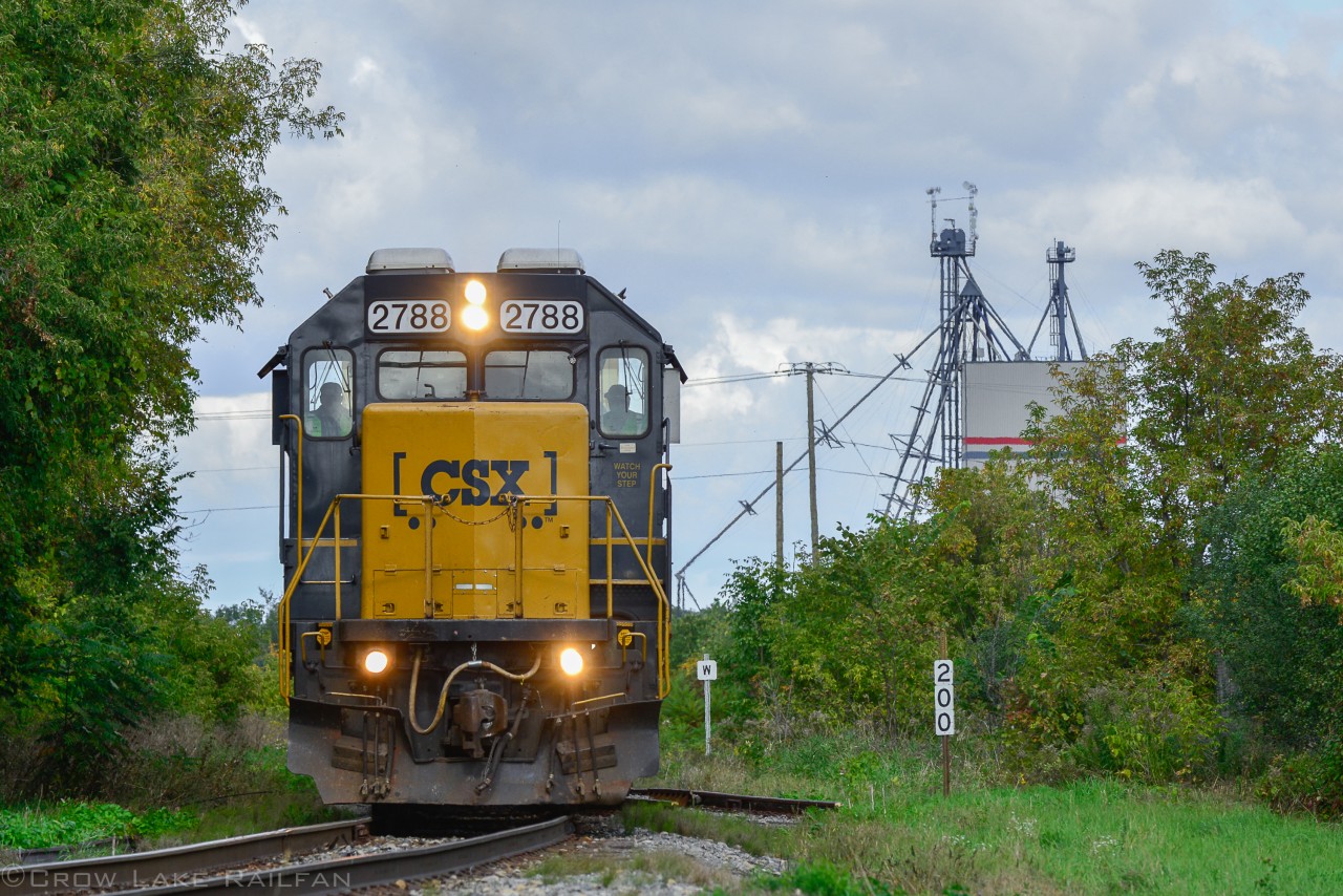 I was on my way after catching CN 327 with its usual CSX power at Les, Cedres and headed south to catch it at the lift bridge at Valleyfield. After a short drive I looked over while I was on the bridge and to my surprise saw a solo GP38-2 slowly pulling about a dozen or so cars south. I then stepped on the gas and started a chase.
Here I made it to a small farming town of Huntingdon where the tracks cut the small town in half. This would be the second to last spot as I headed back north for my original catch. To my dismay it had been delayed a couple hours by the "local". By the time it passed clouds had come over and a storm was approaching. Alas it was still a good surprise catch and chase.