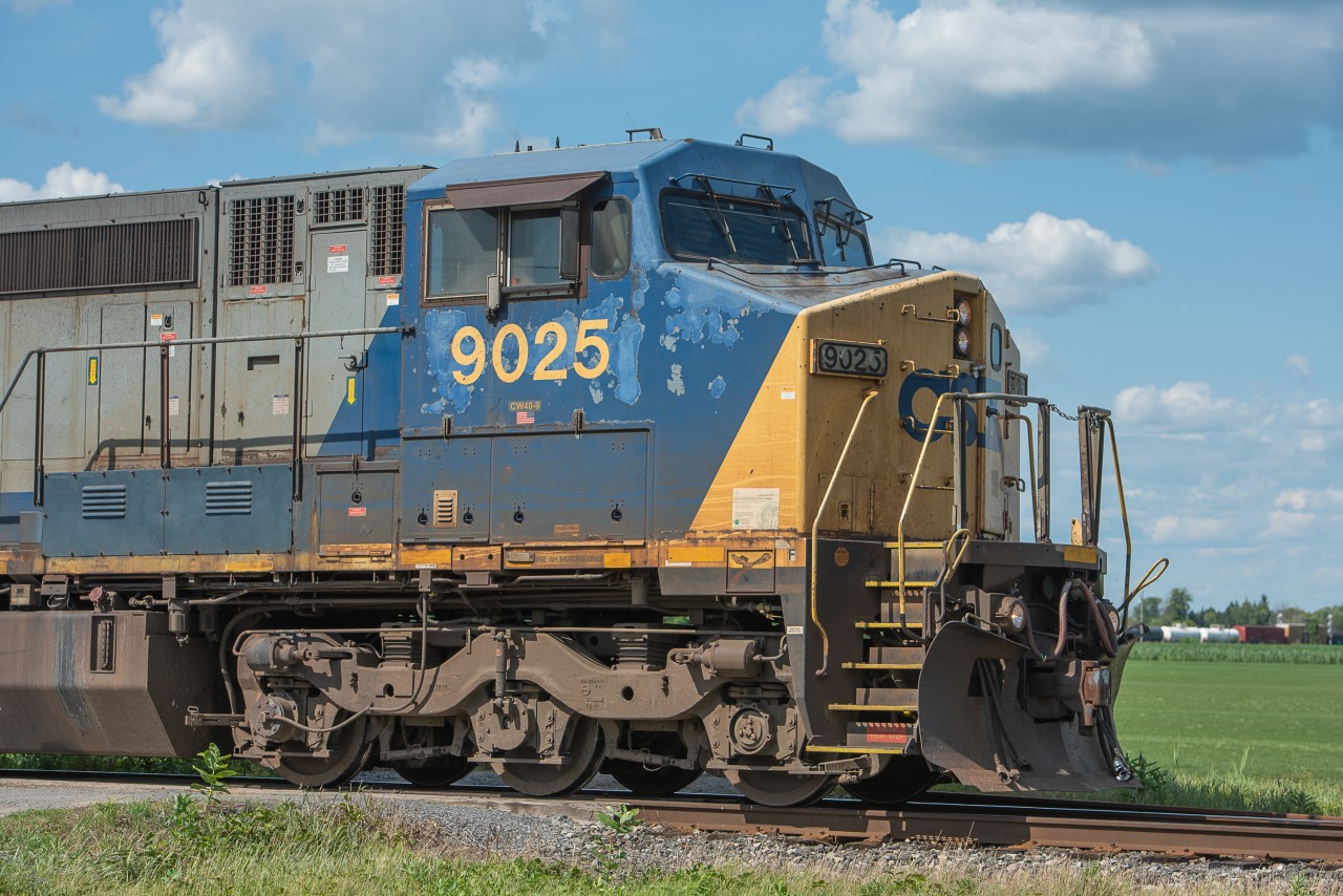 CSXT 9025 slowly rounds the bend at Coteau and prepares to throw the switch onto the Valleyfield Sub. They would drop a considerable amount of cars on the back track before continuing south. In the background is the rest of its train.