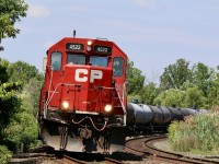 In recent days it seems that H24 has been working Streetsville first then heading to Hornby to work the transfer facility at the old “Expressway “ yard. Fir what ever reason, possibly time, the train has been leaving its train on the branch at Streetsville and heading straight home after working Hornby, typically heading back with only tank cars. On this fourth of July, just before noon former GP40X, now rebuilt GP38 #4522 and a GP20ECO have 31 tank cars in tow as the lean into the curve at the Mississauga Road crossing. 