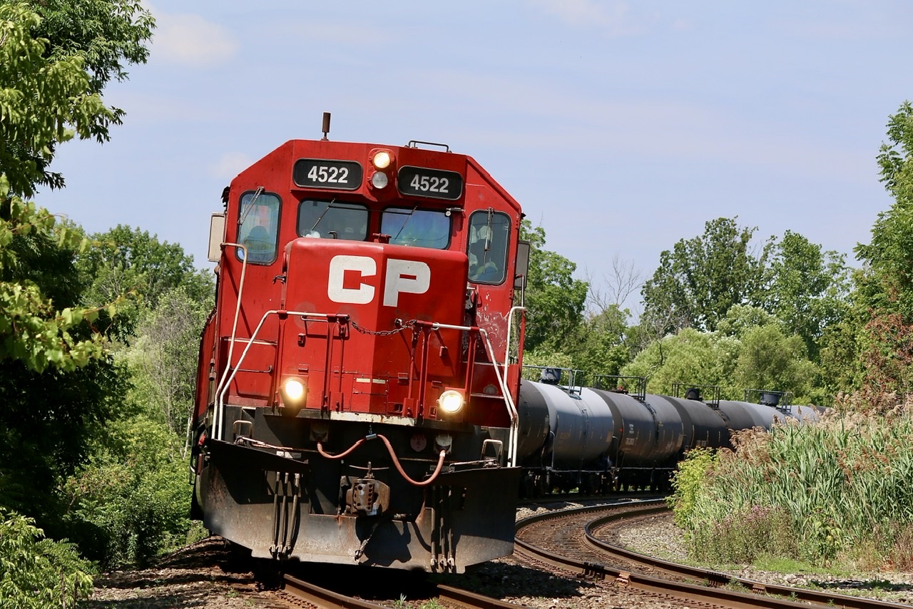 In recent days it seems that H24 has been working Streetsville first then heading to Hornby to work the transfer facility at the old “Expressway “ yard. Fir what ever reason, possibly time, the train has been leaving its train on the branch at Streetsville and heading straight home after working Hornby, typically heading back with only tank cars. On this fourth of July, just before noon former GP40X, now rebuilt GP38 #4522 and a GP20ECO have 31 tank cars in tow as the lean into the curve at the Mississauga Road crossing.