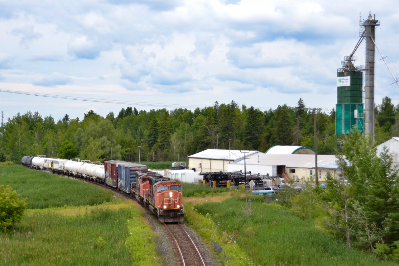 After a hectic week of failures, reroutes and delays, the 2022 CN Weed Spray train rolls down the Bala Subdivision past the Alliance Agri-turf facility in Mount Albert, ON. CN 5722 was put on the head end in Washago earlier that day after CN 5349 ran out of cooling water, adding to the long list of problems this train experienced on its way south.