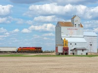 A sign of the changing times...  KCS ET44AC 5018 is the rear DPU on a loaded CP grain train passing the old Pool elevator at Lang Saskatchewan. 