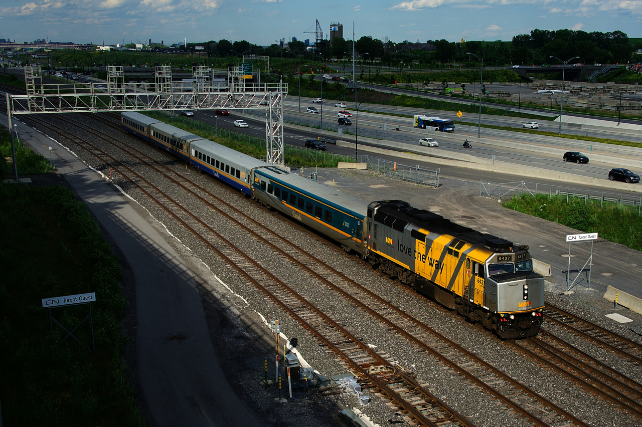 VIA 69 passes Turcot Ouest with VIA 6437 and four LRC cars.