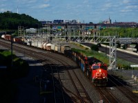 A pair of ET44ACs (CN 3117 & CN 3192) lead a 145-car CN 321 past Turcot Ouest.