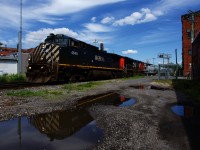 BCOL 4648 is leading CN 527 as it backs up towards Pointe St-Charles Yard. At right another railfan gets a low angle view of the train.