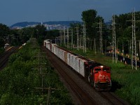 A 128-car CN X377 rounds a curve with a lot of lumber up front and CN 8012 & CN 2230 for power.