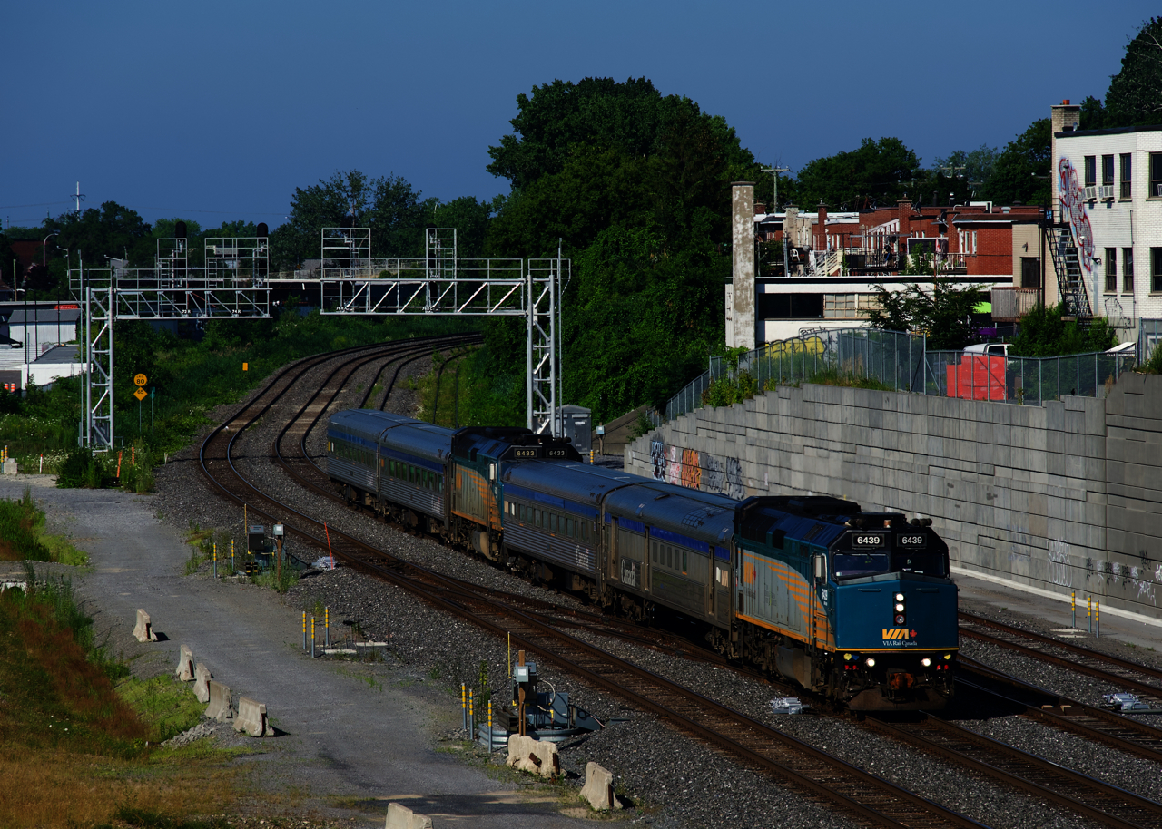 Running for the summer on a primarily overnight and a padded schedule, VIA 604 from Senneterre (the first half of the train) and VIA 600 from Jonquière (the second half of the train) are running early as they approach Turcot Ouest.