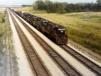 An extra N&W westbound going through Feeder East with lots of power, about to enter CN's original Cayuga Sub. trackage on the way to St. Thomas.  The 1977 camera presented some quality issues but it's a good look back at this section of railroad when it was relatively busy.