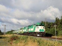 A pair of F59PH GO transit locomotives in GO 562 and GO 557 power their way up to the Watson Road crossing as they exit Guelph. The early morning sun poked out from behind the clouds lighting up the green and white nicely.