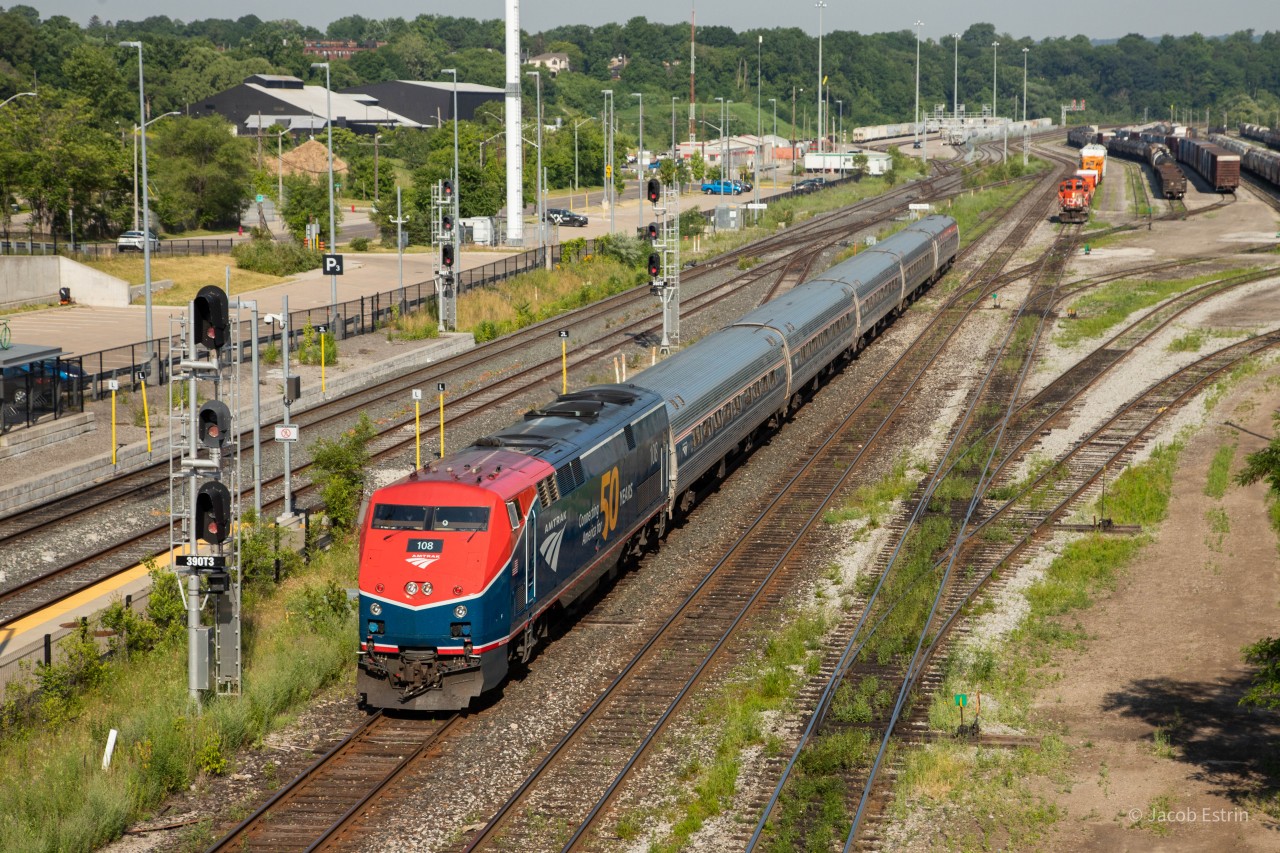 Amtrak's 50th Anniversary unit takes the lead of VIA 97/Amtrak 64 as it passes through Stuart entering the Grimsby Sub.