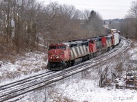 On a dull, dreary February morning a westbound is crossing the Grand River and will soon pass under the John Ave. overpass.