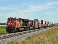 A pair of ET44Acs, CN 3234 and CN 3228 approach Wainwright on the double track at Greenshields
